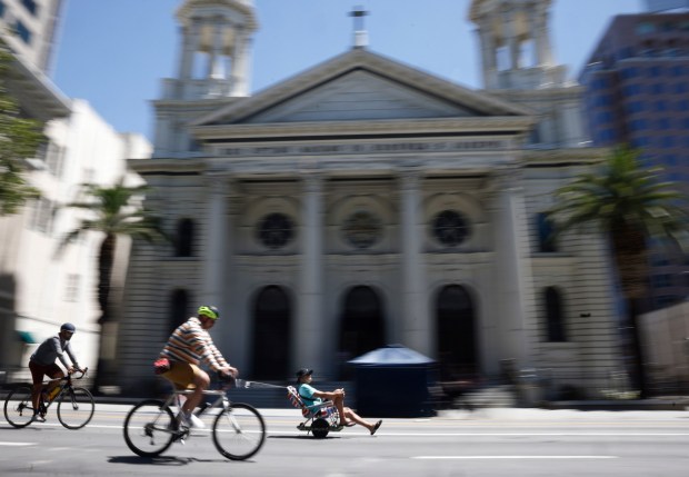 People head south on South Market Street as they ride past Cathedral Basilica of St. Joseph during Viva CalleSJ's "Greetings from San Jose" in downtown San Jose, Calif., on Sunday, June 14, 2026. (Nhat V. Meyer/Bay Area News Group)