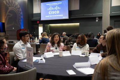 Sandy Yu speaks to a table full of students at the 2026 WILL Conference.