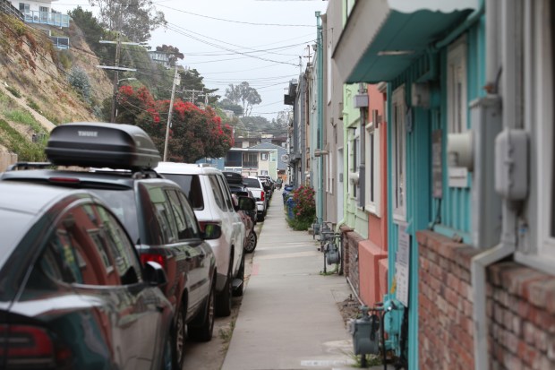 The open sidewalk adjacent to a row of homes along Beach Drive in Aptos that Santa Cruz County leaders and transportation advocates say makes pedestrian and bicycle travel in the area dangerous due to its narrowness and lack of accessibility features. That is why, they argue, the esplanade on the coastal side of the homes is preferred. (PK Hattis Santa Cruz Sentinel)