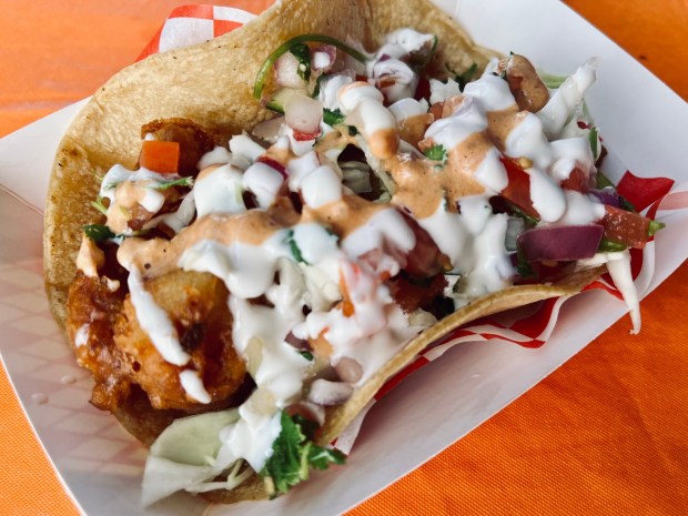 Kiko's Place serves a battered fish taco with Mexican crema, chipotle sauce, pico de gallo and cabbage. (Carlos Rico / The San Diego Union-Tribune)