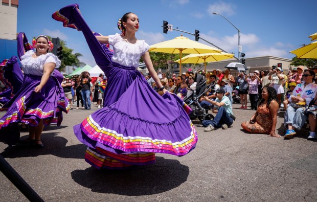 Mariachi dancers from Damza Academy perform during the Chula Vista Lemon Festival along 3rd Avenue in Chula Vista on Saturday, Aug. 16, 2025. This year's Lemon Festival features food and drinks, two stages of live music, a lemon cook-off competition, arts and crafts vendors and several photo op spots. (Sandy Huffaker / For The San Diego Union-Tribune)