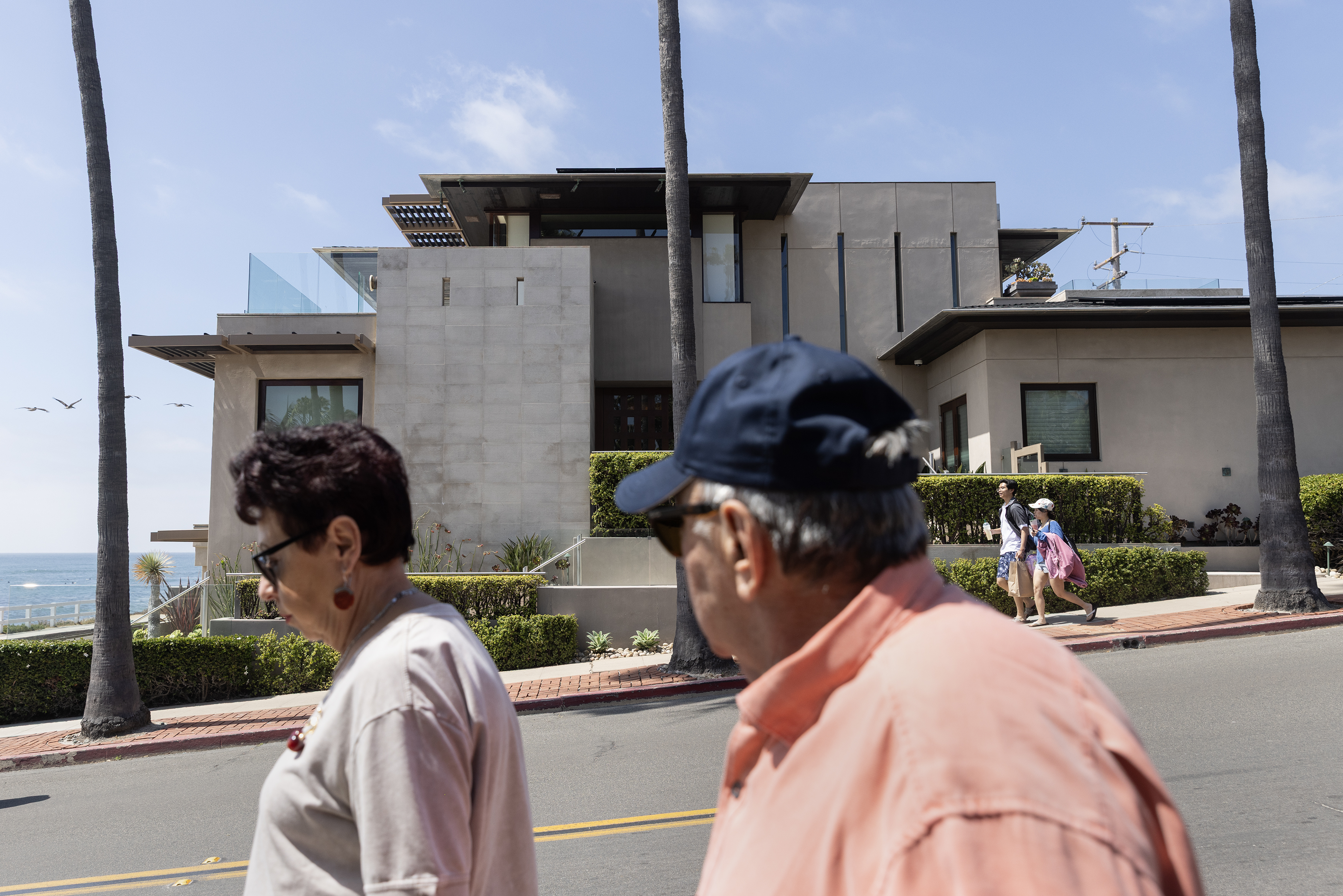 People walk past 210 Palomar Ave. in La Jolla, which...