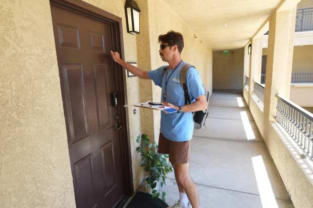 Caleb Farino, a canvasser working for the Yes on A campaign, knocks on door at The Village Mission Valley Apartments on Tuesday, June 2, 2026 in San Diego, CA. (Michael Ho / For The San Diego Union-Tribune)