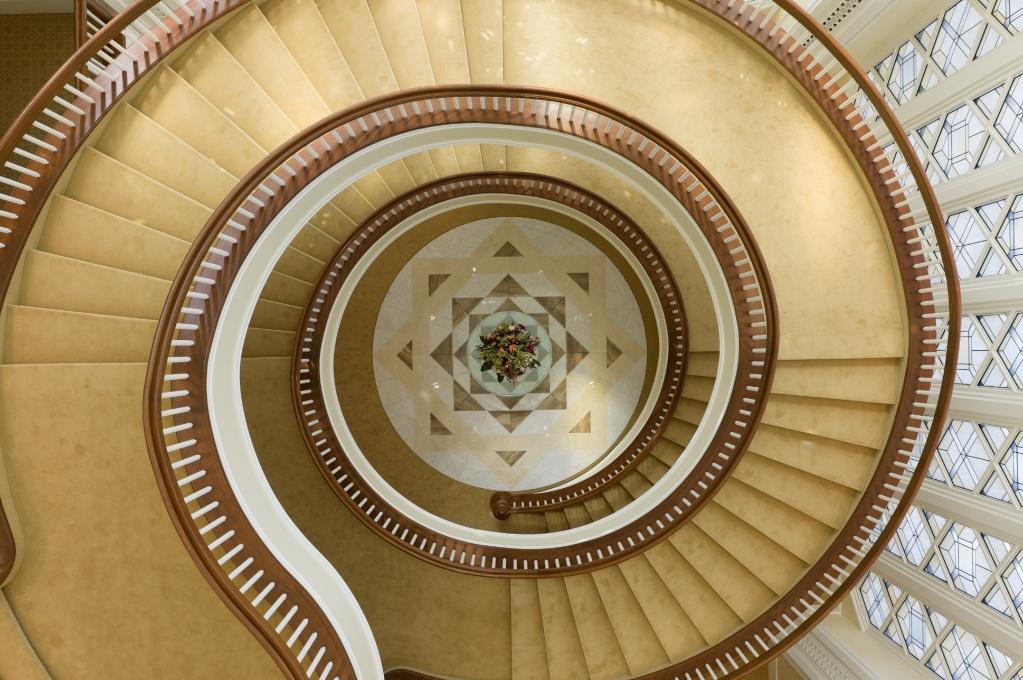 View looking down the towering staircase that goes up four...