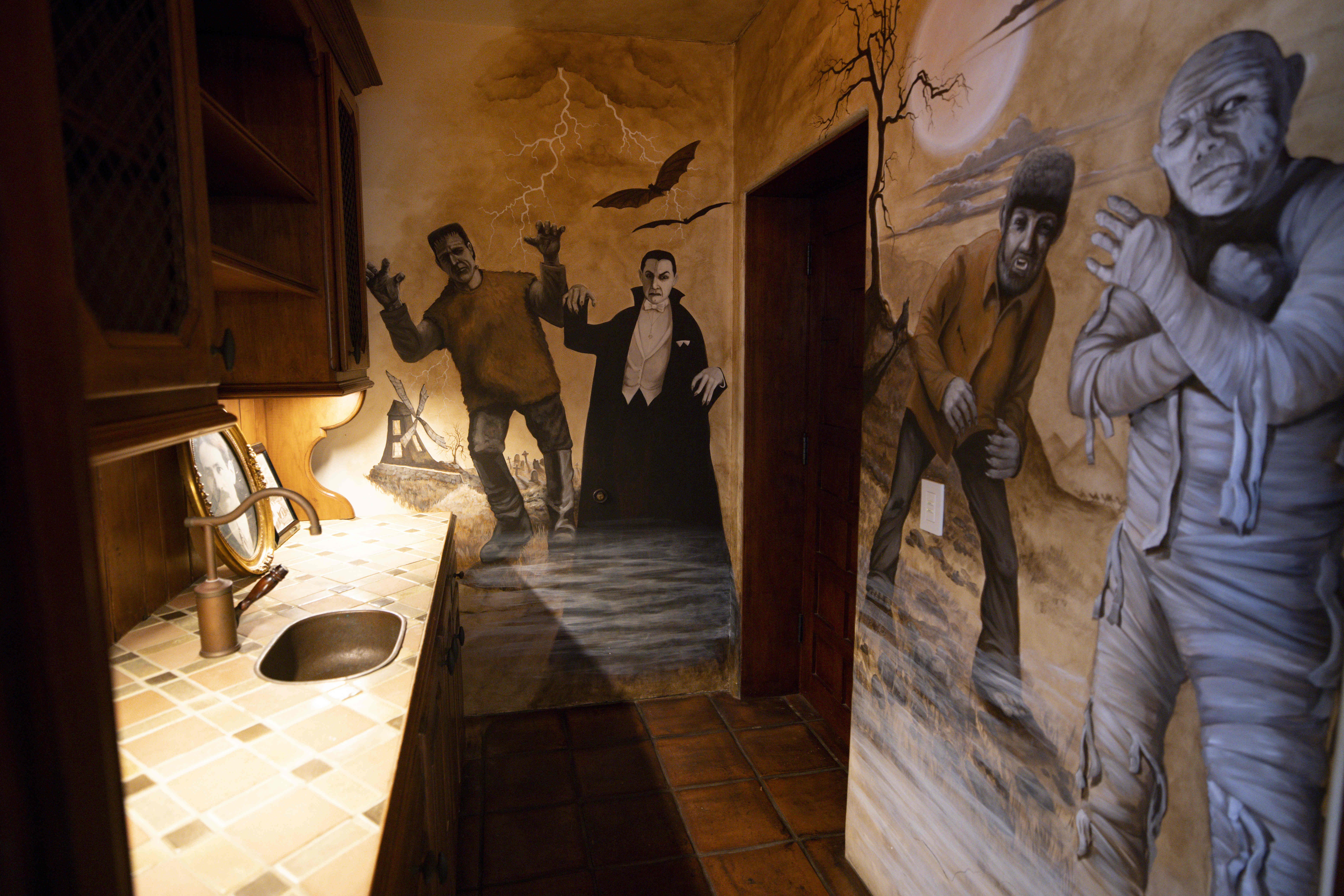 A mural of horror movie characters outside a home movie...
