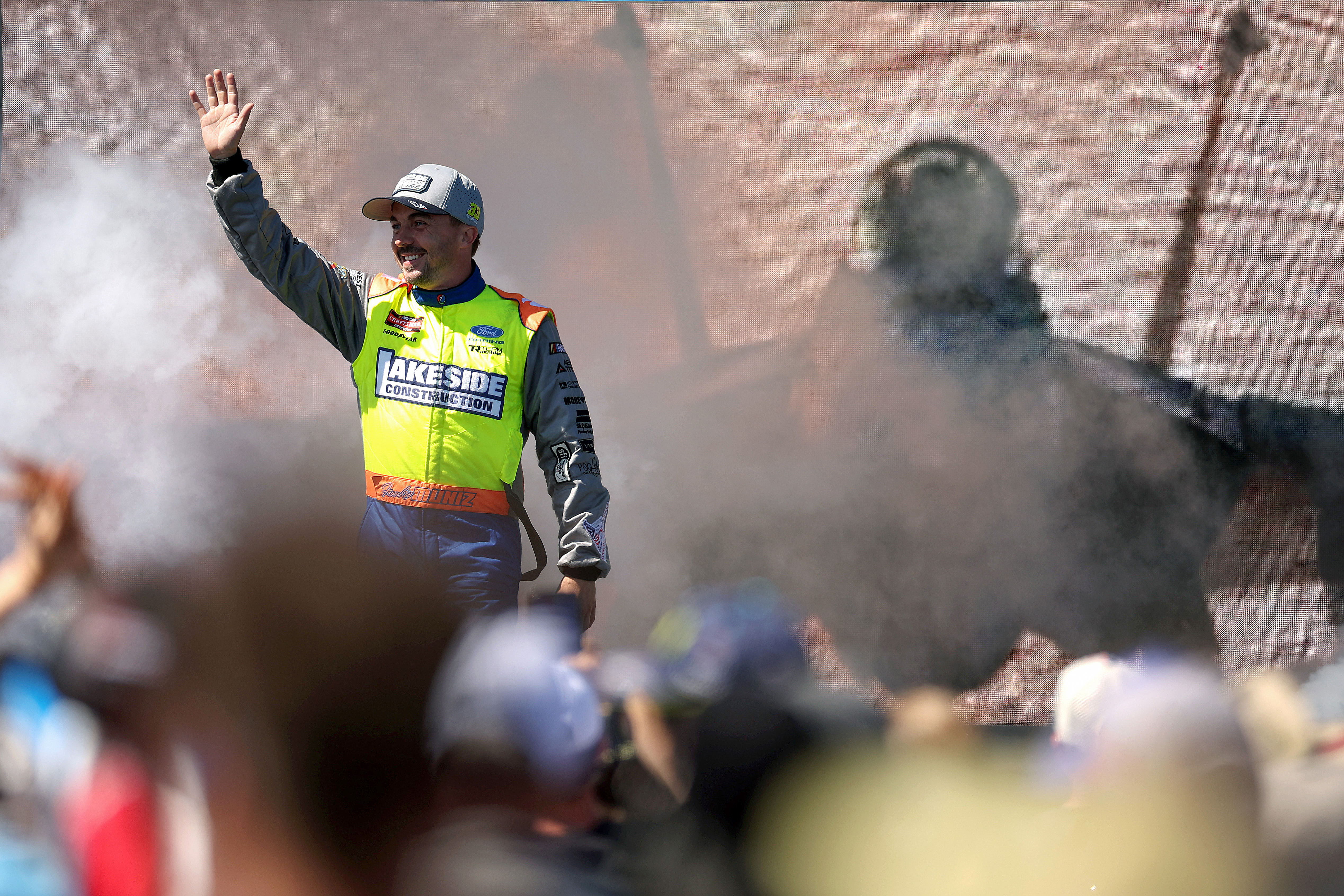 Frankie Muniz, driver of the #33 Lakeside Construction Ford, waves...