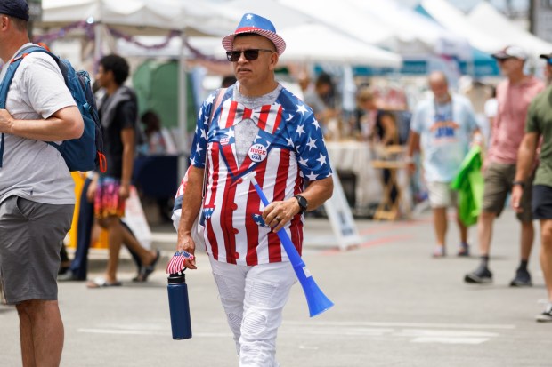 Victor Contreras walks around wearing an American-themed outfit during the USA 250 festival in Oceanside on Saturday, June 27, 2026. (Kristian Carreon / The San Diego Union-Tribune)
