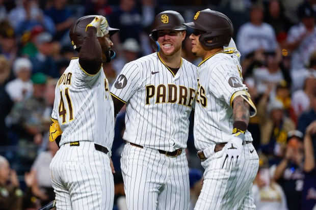Miguel Andujar, Gavin Sheets and Manny Machado celebrate after Machado's home run against the Philadelphia Phillies during the fourth inning at Petco Park on Tuesday, May 26, 2026 in San Diego, California. (Meg McLaughlin / The San Diego Union-Tribune)