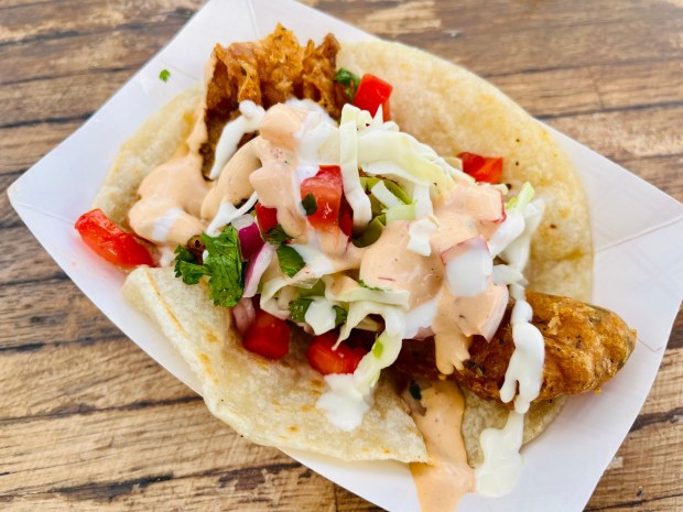 Quinero Restaurant's fish taco is beer-battered with cabbage, pico de gallo, chipotle and lime aioli sauce on a flour tortilla. (Carlos Rico / The San Diego Union-Tribune)