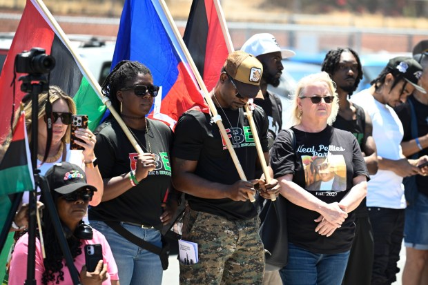 People look on as the restored Black Family Statue designed by artist Rossie S. Wade is unveiled at Neal Petties Mountain View Community Park June 13, 2026 in San Diego, Calif. (Denis Poroy / For The San Diego Union-Tribune)