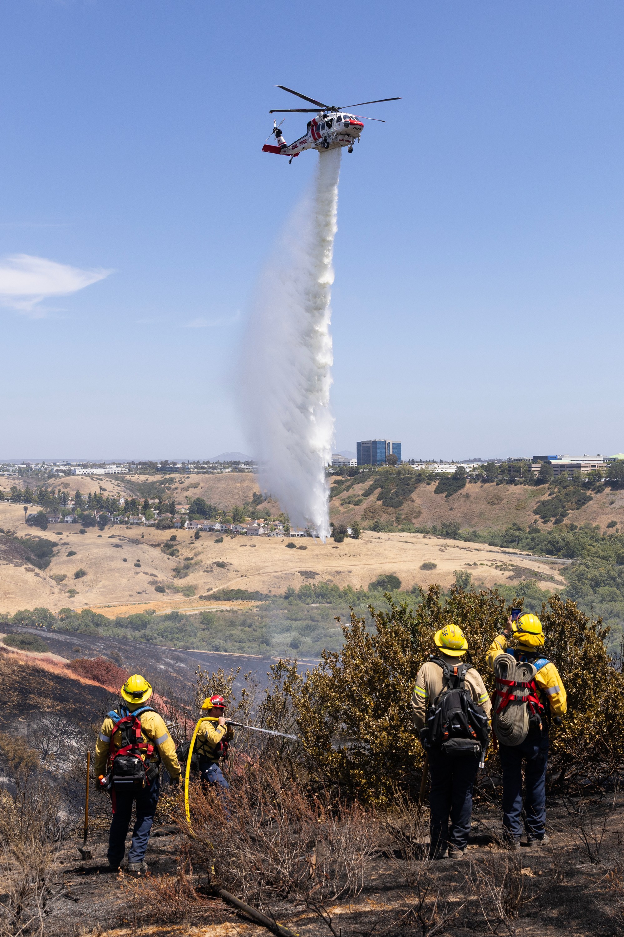 San Diego, CA – Crews battle the Sorrento Fire in...