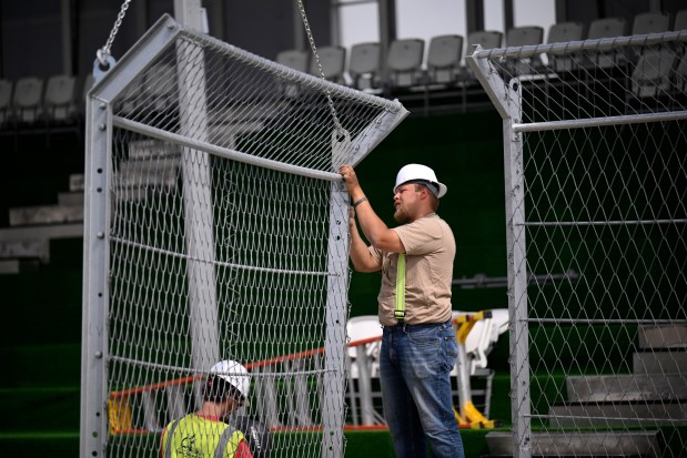 A general view of construction workers installing fencing to the top of concrete barriers for the NASCAR San Diego course at the Naval Base Coronado on June 09, 2026 in Coronado, California. (Photo by Orlando Ramirez/Getty Images)