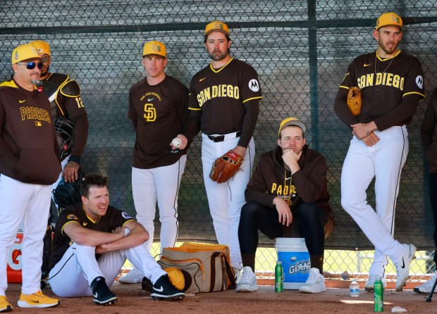 Padres pitching coach Ruben Niebla, left, and pitchers Nick Pivetta (sitting), JP Sears, Matt Waldron, Michael King, and Joe Musgrove watch a bullpen session during a spring training practice on February 19, 2026 in Peoria, AZ. (K.C. Alfred / The San Diego Union-Tribune)