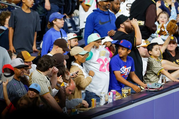 A fan wearing a Padres Juan Soto jersey tries to get the outfielder's attention during the fifth inning of the Padres game against the New York Mets at Petco Park on Friday, June 5, 2026 in San Diego, California. (Meg McLaughlin / The San Diego Union-Tribune)