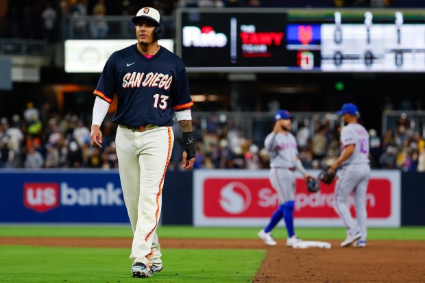 Manny Machado #13 of the San Diego Padres walks back to the dugout as Bo Bichette #19 and Marcus Semien #10 of the New York Mets celebrate after defeating the Friars at Petco Park on Friday, June 5, 2026 in San Diego, California. (Meg McLaughlin / The San Diego Union-Tribune)