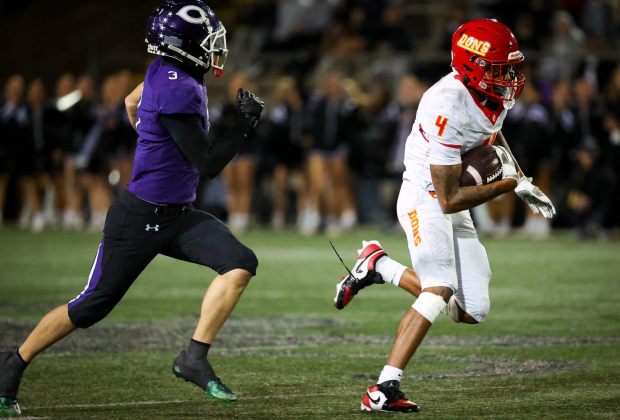 Cathedral Catholic wide receiver Isaac Cook runs the ball against Carlsbad's Ethan Meyerhoff during the CIF San Diego Section Open Division finals at Southwestern College on Tuesday, Nov. 25, 2025 in San Diego, California. (Meg McLaughlin / The San Diego Union-Tribune)