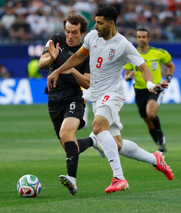 Mehdi Taremi #9 of Iran controls the ball against Joe Bell #6 of New Zealand during a FIFA World Cup 2026 match at Los Angeles Stadium on June 15, 2026 in Inglewood, California. (Photo by K.C. Alfred / The San Diego Union-Tribune via Getty Images)