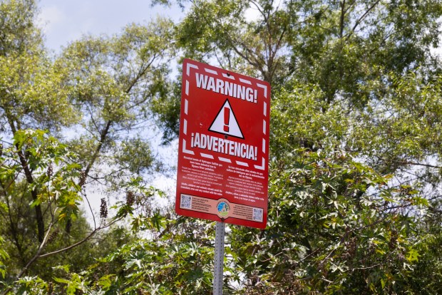 Imperial Beach, CA - A warning sign just off the known Saturn Boulevard hot spot on Thursday, June 11, 2026, in Imperial Beach, CA. (Luke Johnson / The San Diego Union-Tribune)