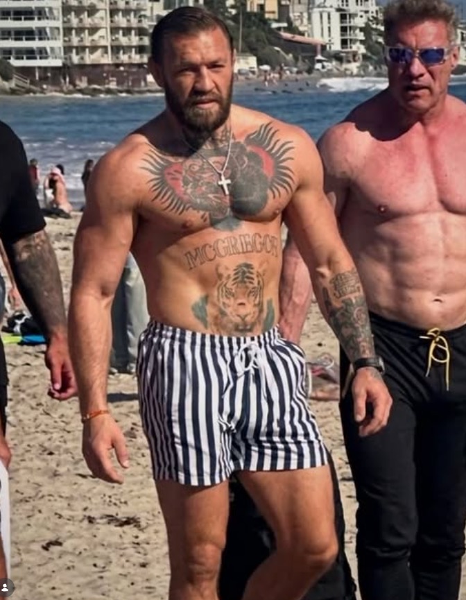 Conor McGregor shirtless on a beach.