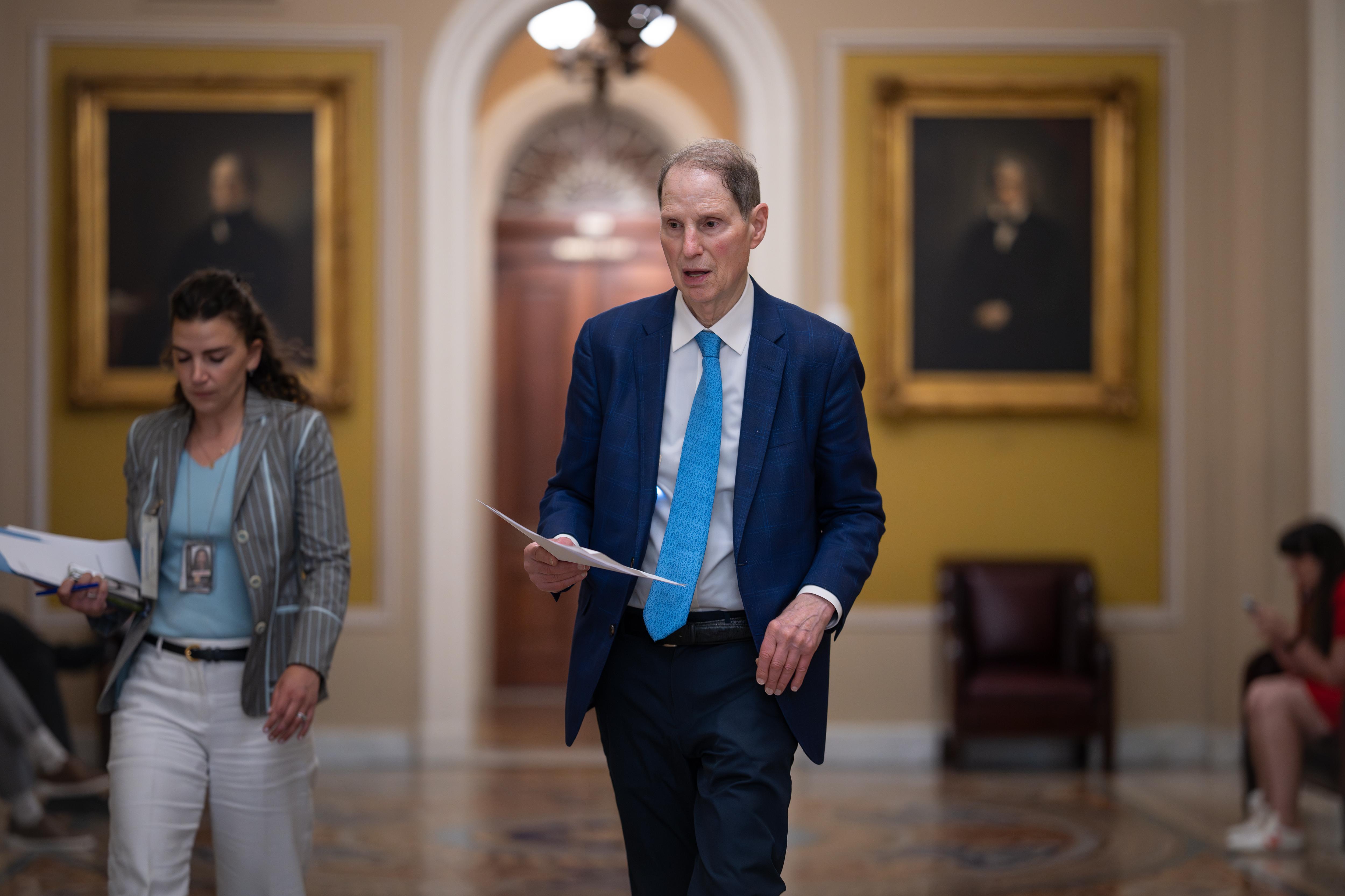 Sen. Ron Wyden, D-Ore., walks to the chamber.