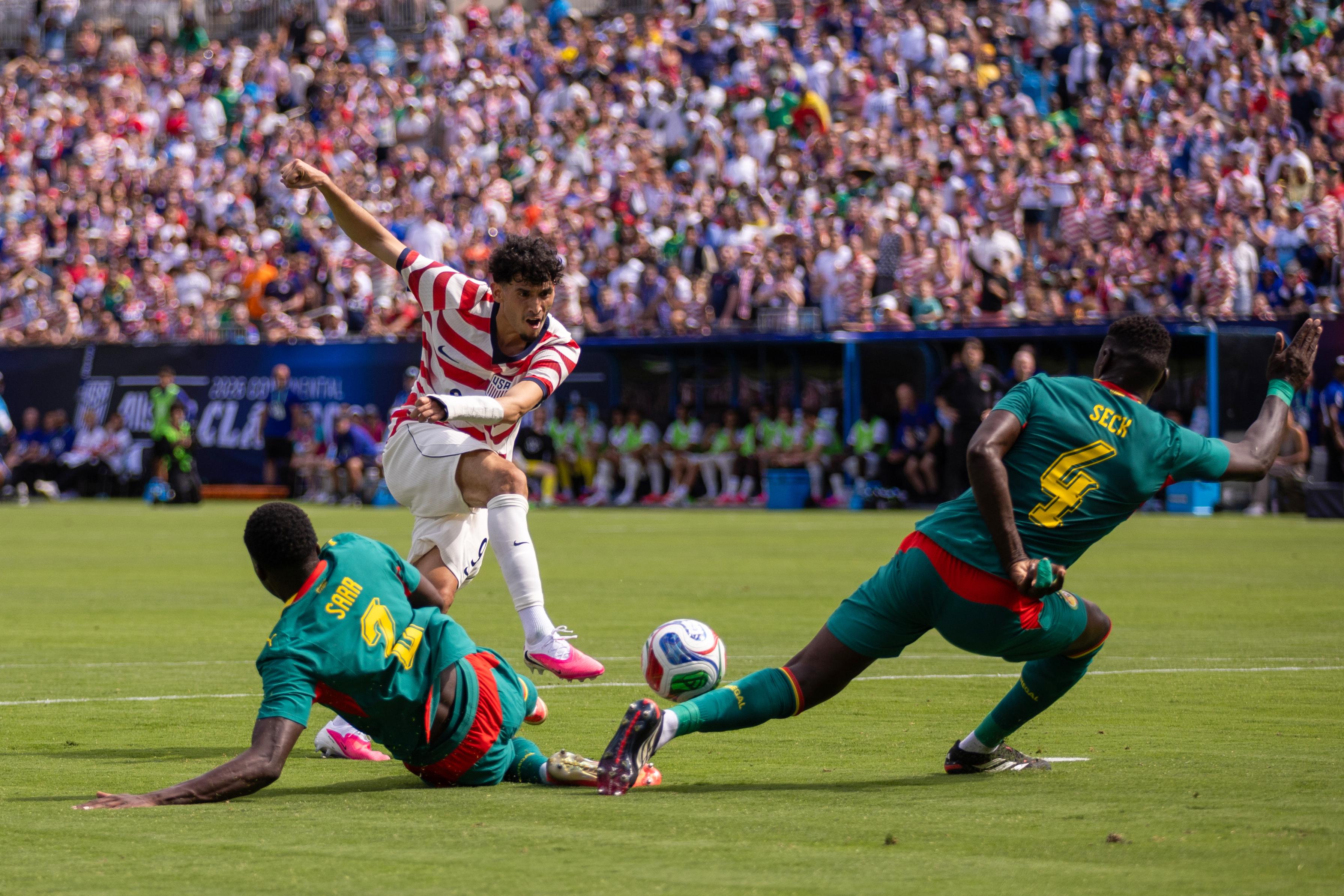 Forward Ricardo Pepi has a shot blocked by Senegal defender Abdoulaye Seck.