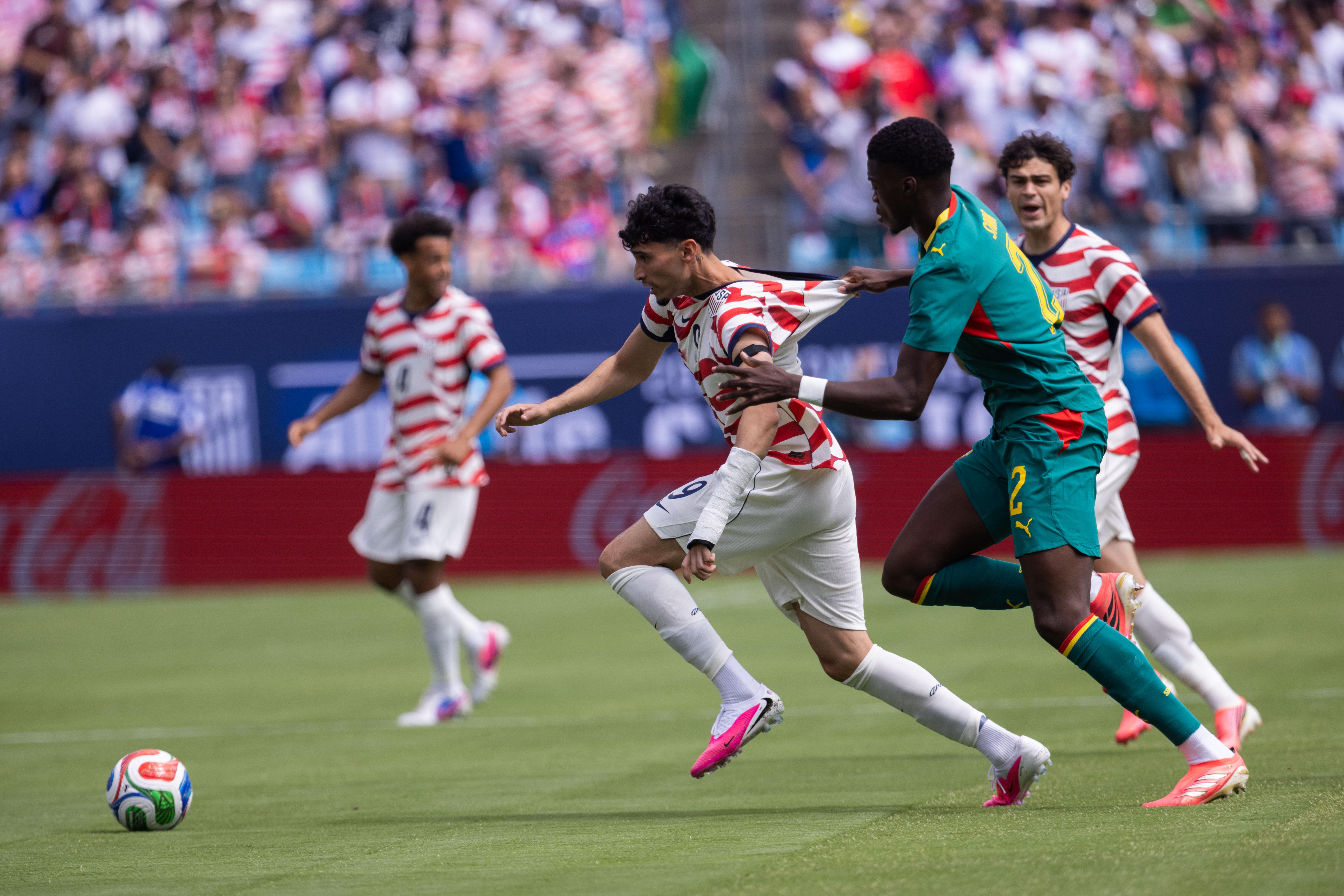 United States forward Ricardo Pepi, front left, is grabbed by...