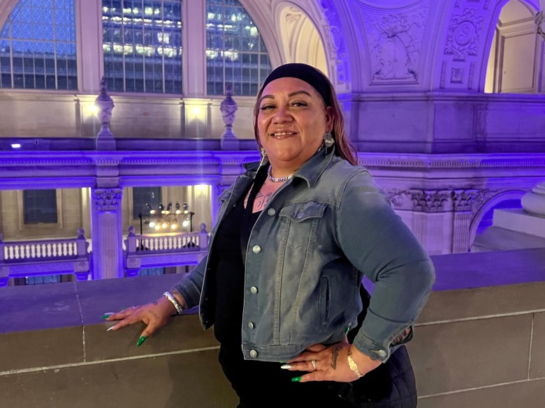 Woman poses in City Hall proudly