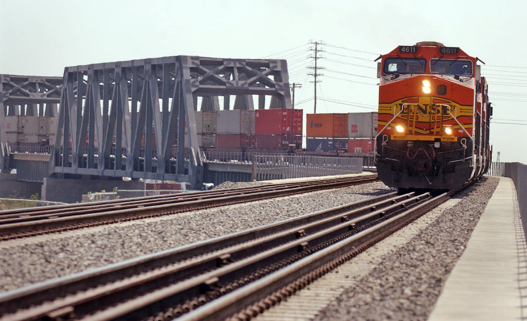 A freight train traveling the Alameda Corridor crosses the Dominguez...
