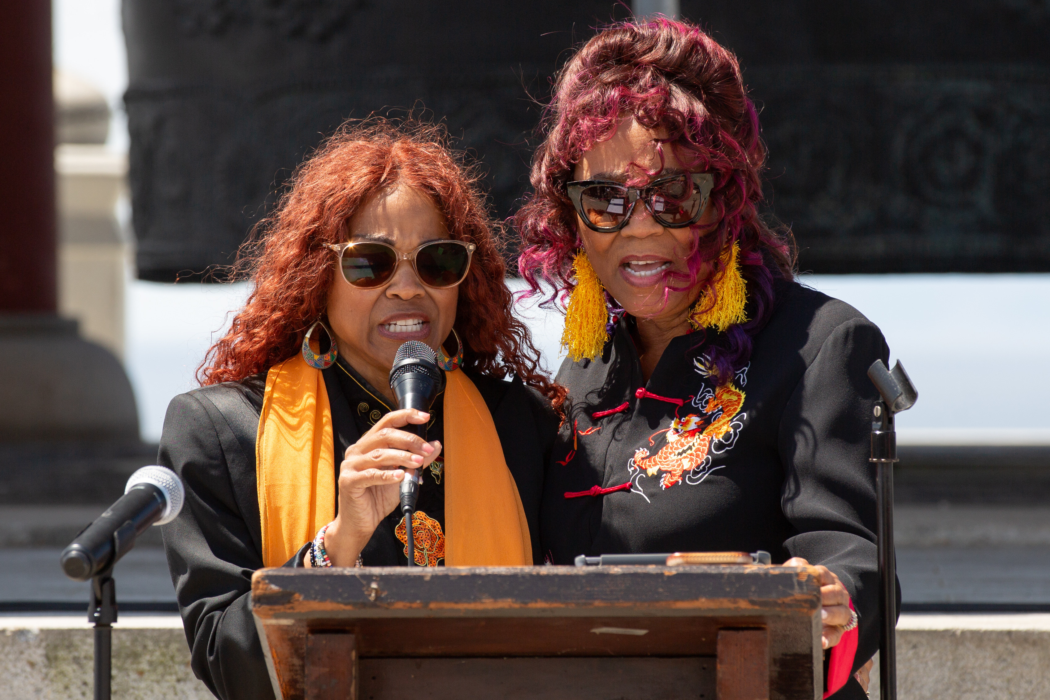 Singers Windy Farrell, left, and Sunny Daye sing together during...