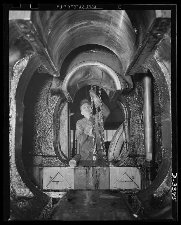 1942: A huge forge hammer in an automobile plant is converted to war work in Lansing, Michigan. The importance of the auto in American life is proving to be a tremendous advantage as the great automotive plants pool their resources in the mightiest war production effort the world has ever seen. (Photo courtesy Library of Congress)