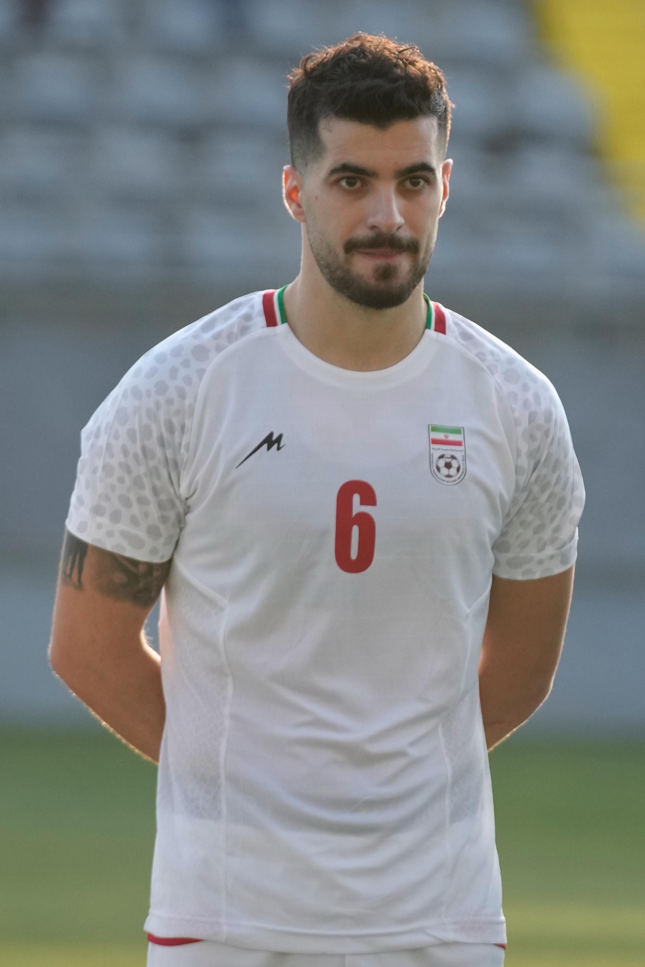 Iran’s Saeid Ezatolahi listens to national anthems prior to a...