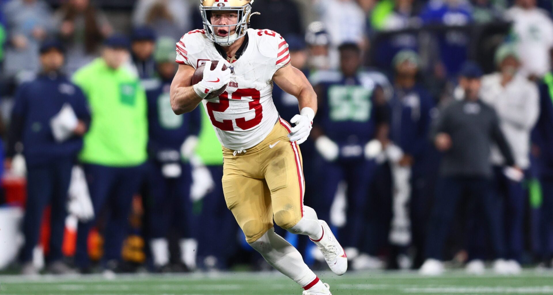 Jan 17, 2026; Seattle, WA, USA; San Francisco 49ers running back Christian McCaffrey (23) runs after the catch against the Seattle Seahawks during the first half in an NFC Divisional Round game at Lumen Field.