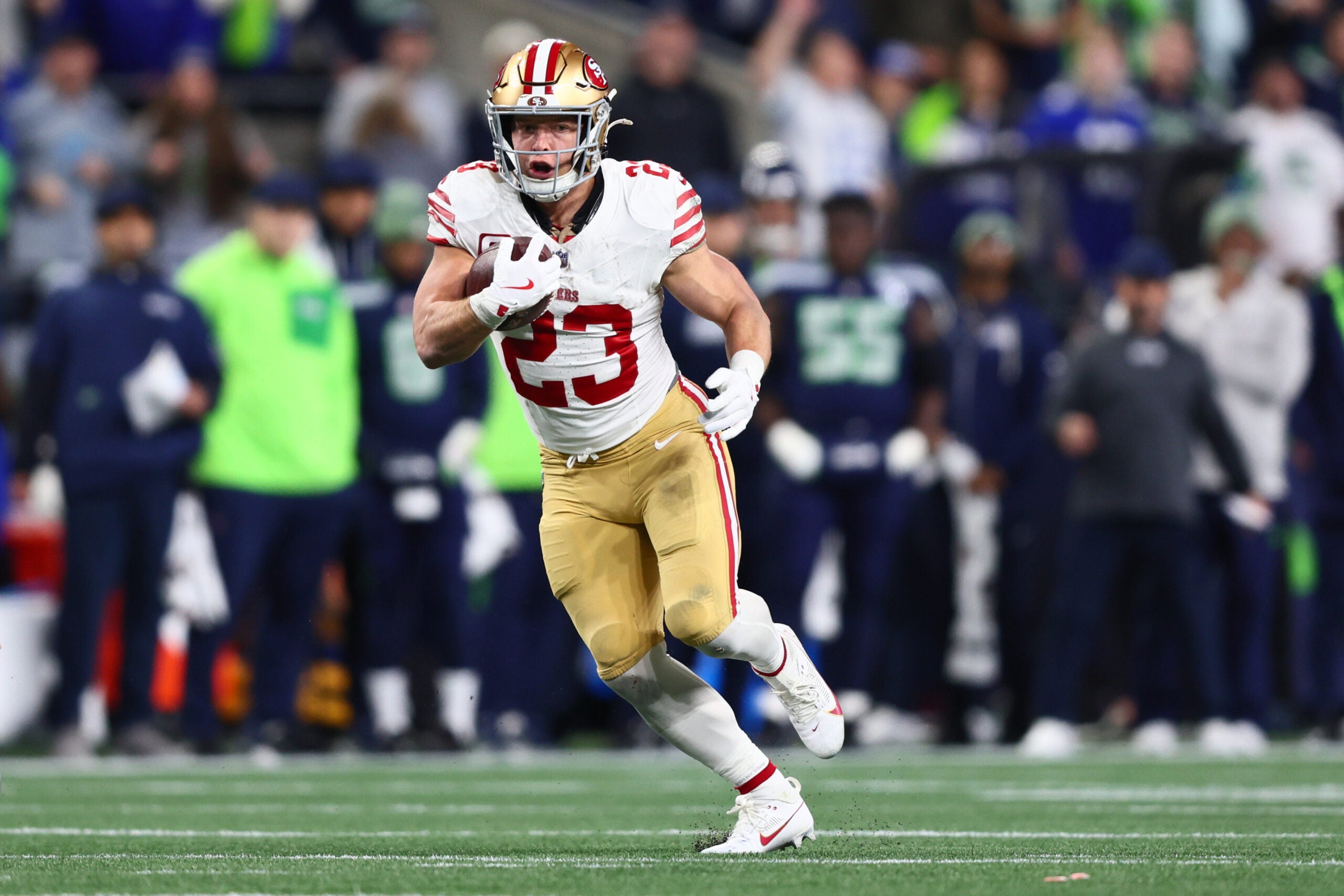 Jan 17, 2026; Seattle, WA, USA; San Francisco 49ers running back Christian McCaffrey (23) runs after the catch against the Seattle Seahawks during the first half in an NFC Divisional Round game at Lumen Field.