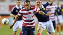 United States midfielder Landon Donovan (10) is tripped up by Scotland midfielder Scott Brown (right) in first half action of the U.S. men's national soccer team against Scotland Saturday, May 26, 2012 in Jacksonville, Florida. [Will Dickey/Florida Times-Union]