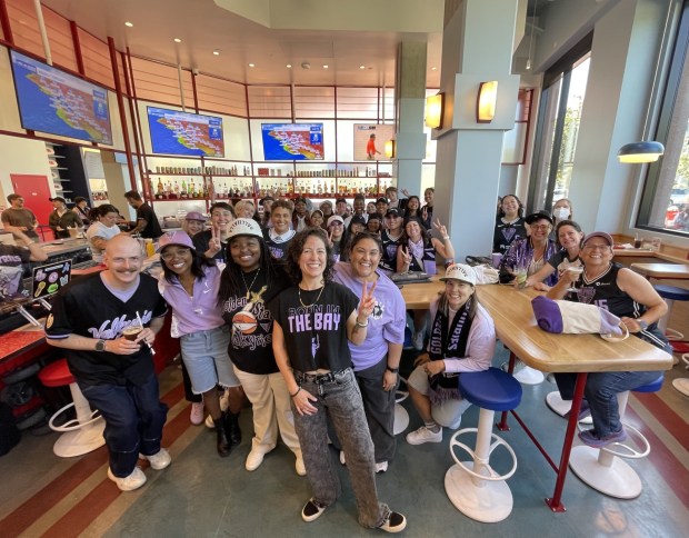 Megan Doherty-Baker (center), struck by the numerous LGBTQ+ fans at the first Golden State Valkyries game at Chase Center in 2025, decided to launch the ValQueeries, a fan group for LGBTQ+ Valkyries' supporters. (JL Odom/Bay City News)