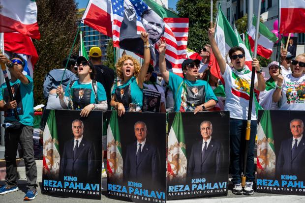 People chant and cheer during a protest in reaction to FIFA's ban of Iran's pre-revolutionary flag inside World Cup stadiums Sunday, June 7, 2026, in Inglewood, Calif. (AP Photo/Benjamin Hanson)