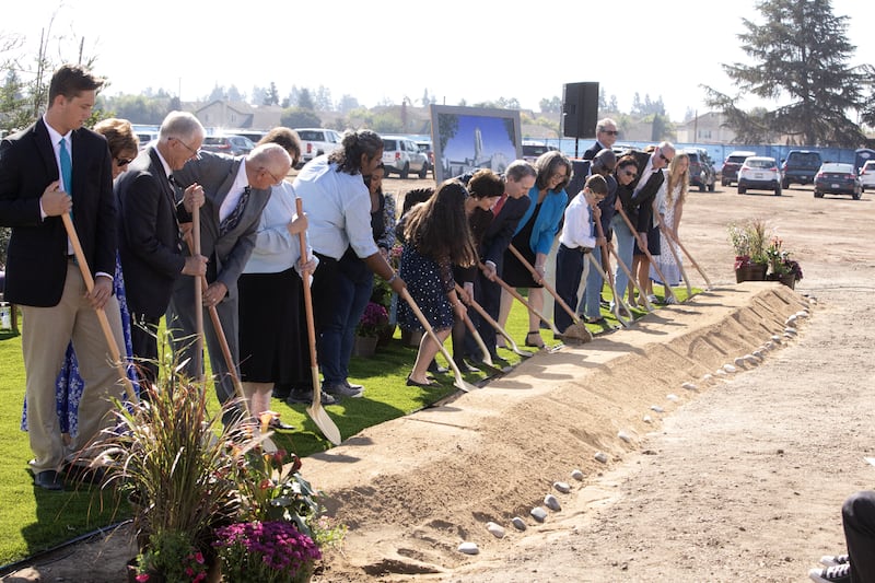 Elder Gary B. Sabin, center, and his wife, Sister Valerie Sabin, lead invited guests in turning shovels of dirt at the Modesto California Temple groundbreaking on Saturday, Oct. 7, 2023, in Modesto, California.