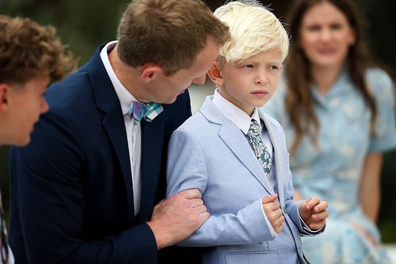 Dylan McMurtry and his son Leo, sit on the grounds of the San Diego California Temple on Monday, June 15, 2026.