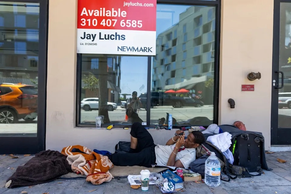 A homeless man camps out near a vacant storefront on the Sunset Strip. Jesal for CA Post