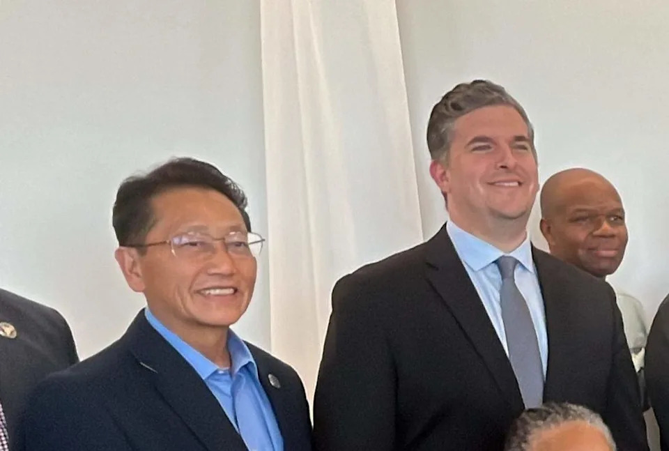 Fresno city councilmembers Brandon Vang, left, and Tyler Maxwell pose for a photo at the May 22, 2026 dedication for the late Henry Thompson at the Fresno Yosemite International Airport. Maxwell criticized Vang for saying the Eviction Protection Program would be cut.