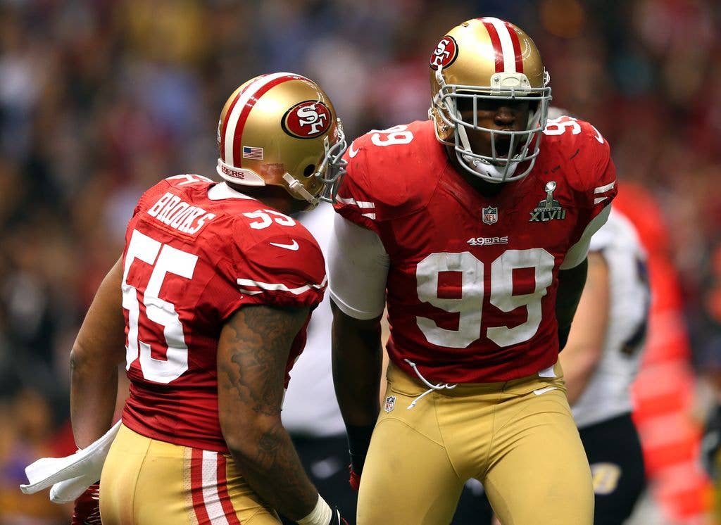 Aldon Smith #99 of the San Francisco 49ers celebrates a sack with teammate  Ahmad Brooks #55 against the Baltimore Ravens during Super Bowl XLVII at the Mercedes-Benz Superdome on February 3, 2013 in New Orleans, Louisiana
