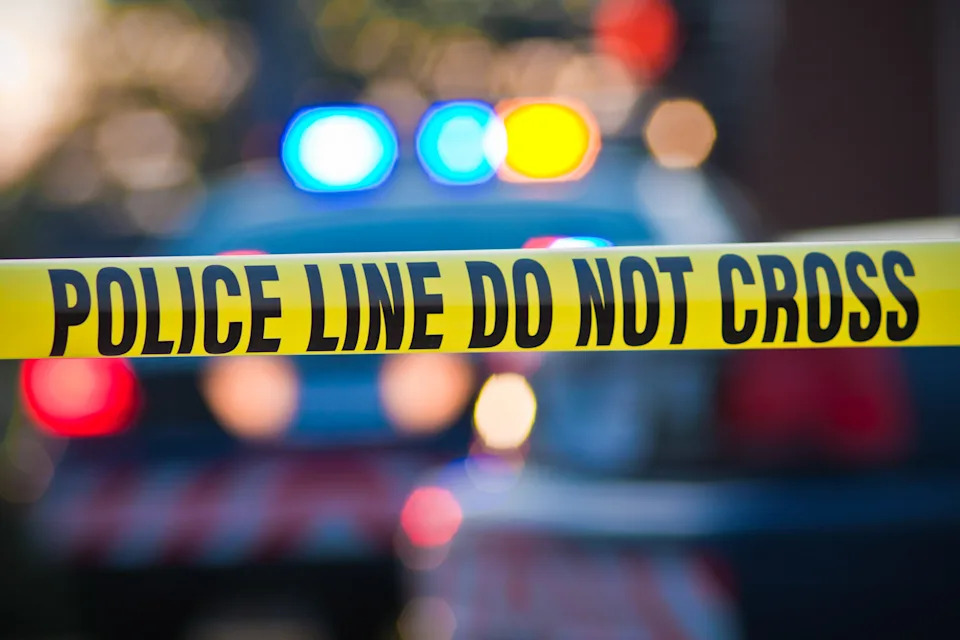 Lellow law enforcement tape at a crime scene.