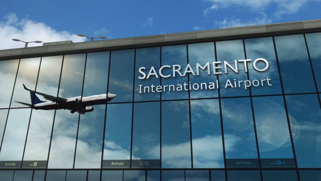 Illustration of a plane reflected in the glass facade of Sacramento International Airport.
