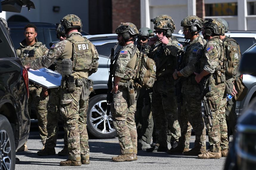 FBI agents respond after a man barricaded himself inside a bank Tuesday, June 2, in Bakersfield, Caifornia.