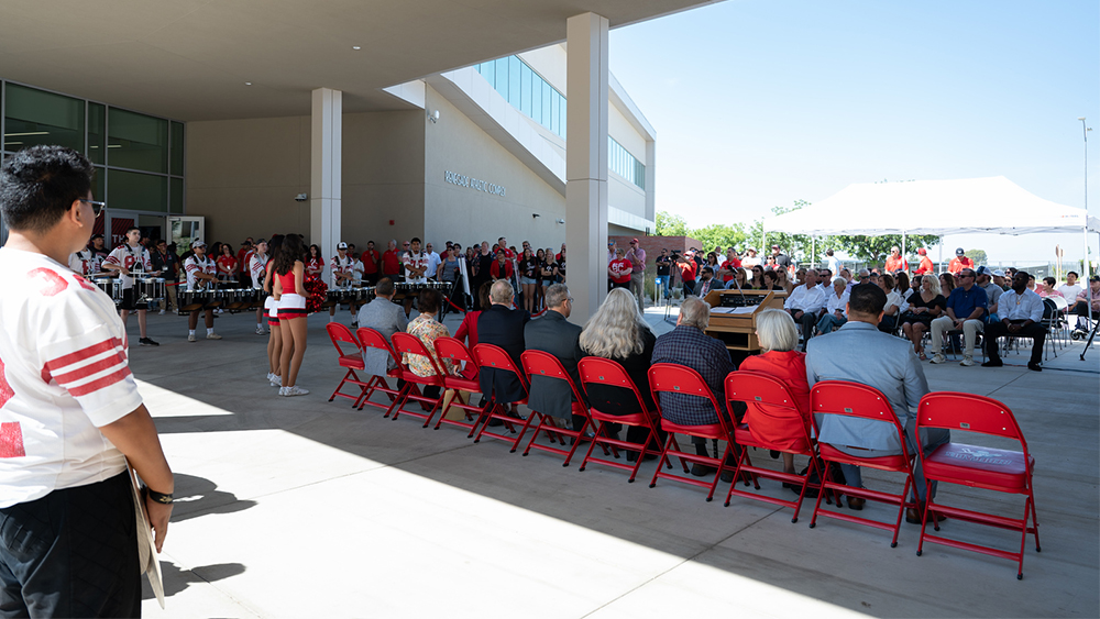 large group of people present at the ribbon cutting ceremony of the new gym