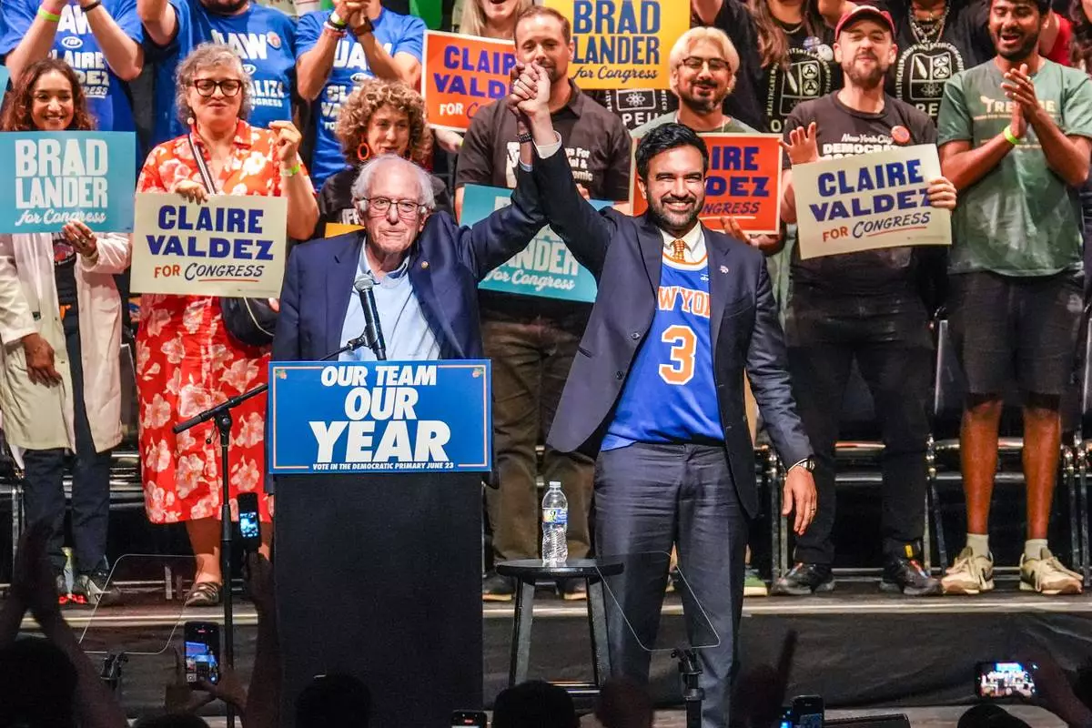 Mayor Zohran Mamdani, right, gestures on stage with U.S. Sen. Bernie Sanders, I-VT., during a Get Out The Vote rally ahead of New York's primary election, Thursday, June 18, 2026, in the Brooklyn borough of New York. (AP Photo/Ryan Murphy)