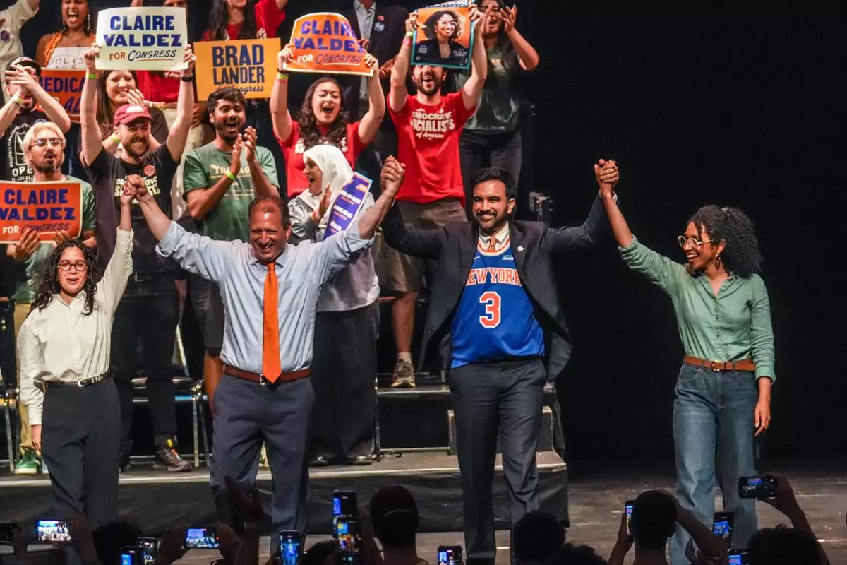 Democratic congressional candidates, Claire Valdez, Brad Lander, and Darializa Avila Chevalier gesture on stage with Mayor Zohran Mamdani during a Get Out The Vote rally ahead of New York's primary election, Thursday, June 18, 2026, in the Brooklyn borough of New York. (AP Photo/Ryan Murphy)