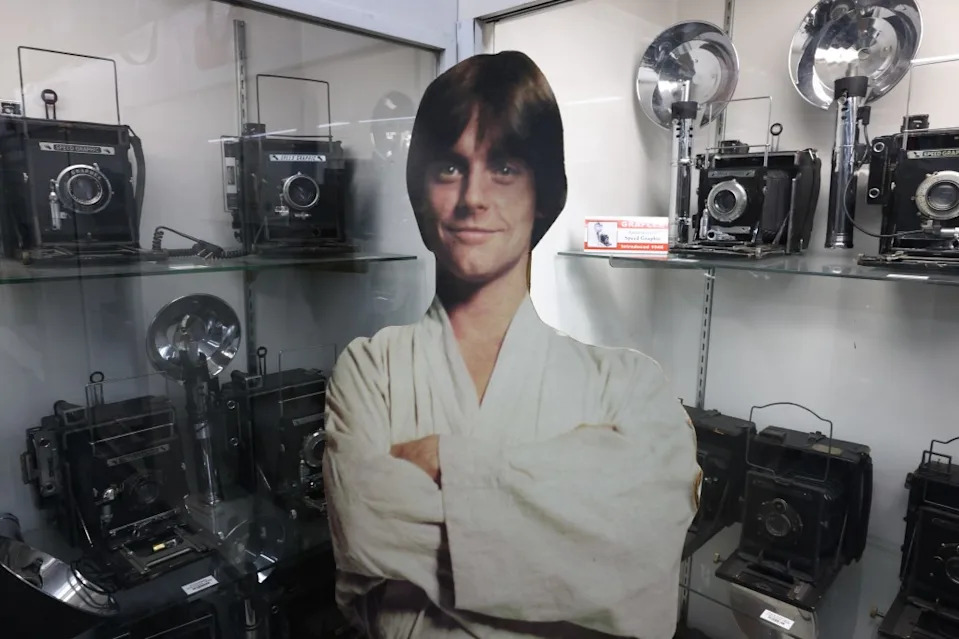 A Luke Skywalker cardboard cutout stands in a display of vintage cameras at History For Hire prop house. Jonathan Alcorn for CA Post