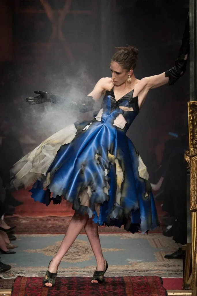 Model presents a blue Moschino Fall 2016 gown with a distressed hem on the runway.
