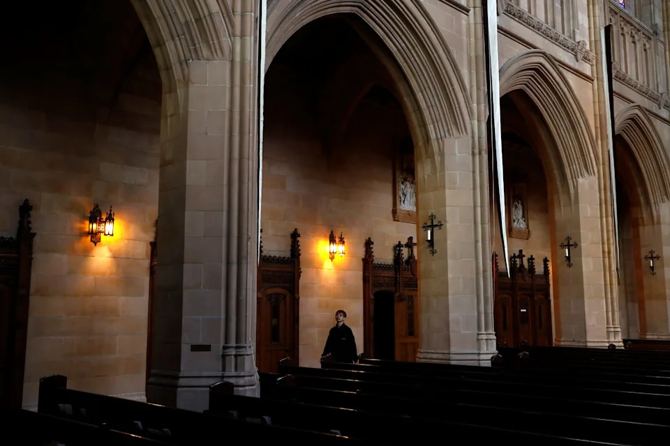 A visitor walks inside an empty St. Dominic's Catholic Church as California continues its statewide "stay at home order" directing the state's 40 million residents to stay in their homes in the face of the fast-spreading coronavirus disease (COVID-19) in San Francisco, California, U.S. March 23, 2020. REUTERS/Stephen Lam